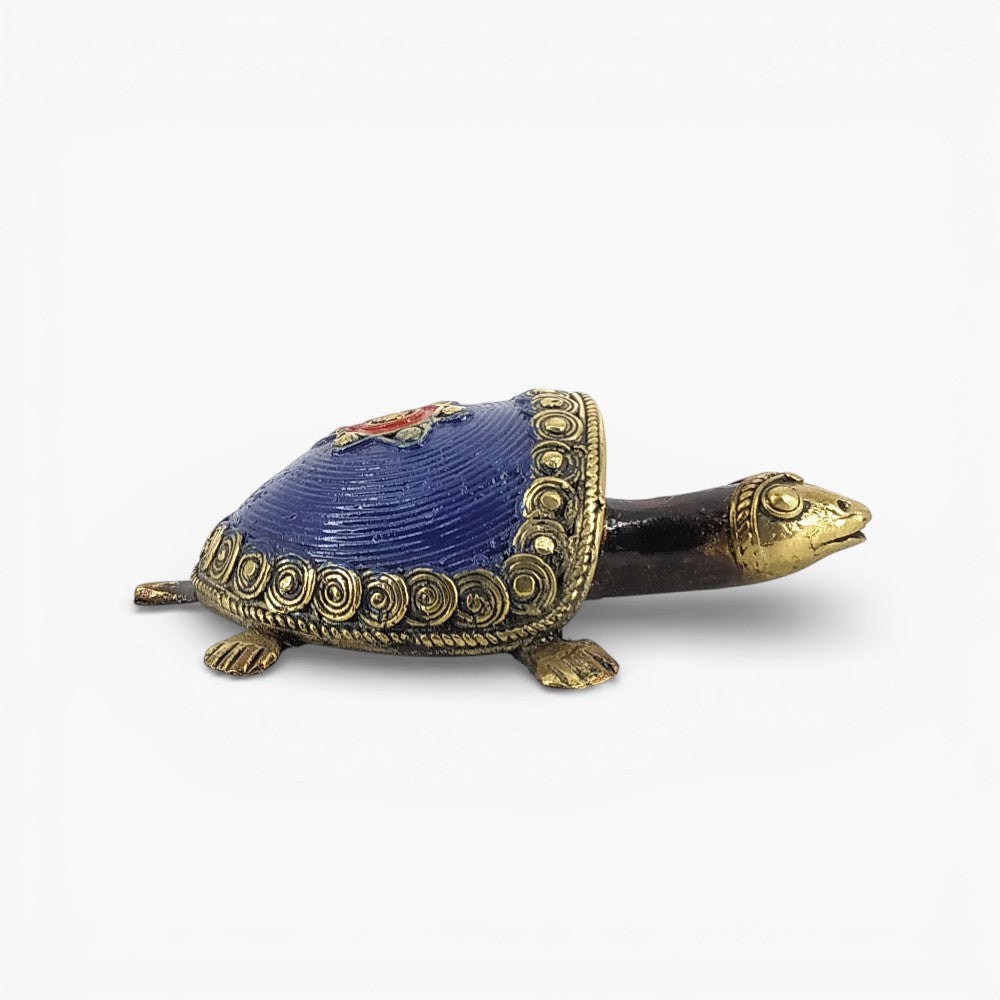 Side profile of handmade tribal art bell metal coin tortoise figurine showing elongated neck and detailed shell edging