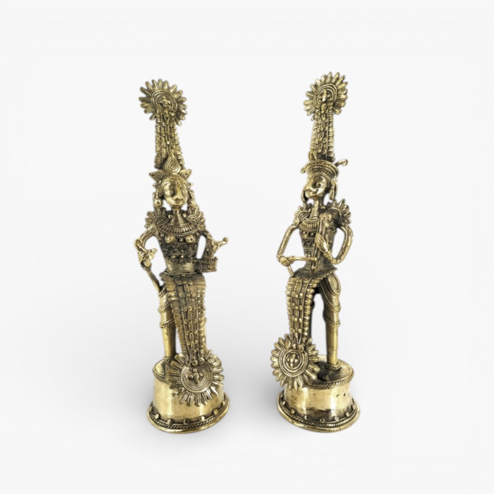 Angled view of brass Jhitku Mitki tribal couple statue highlighting musical instruments and intricate Dokra art motifs