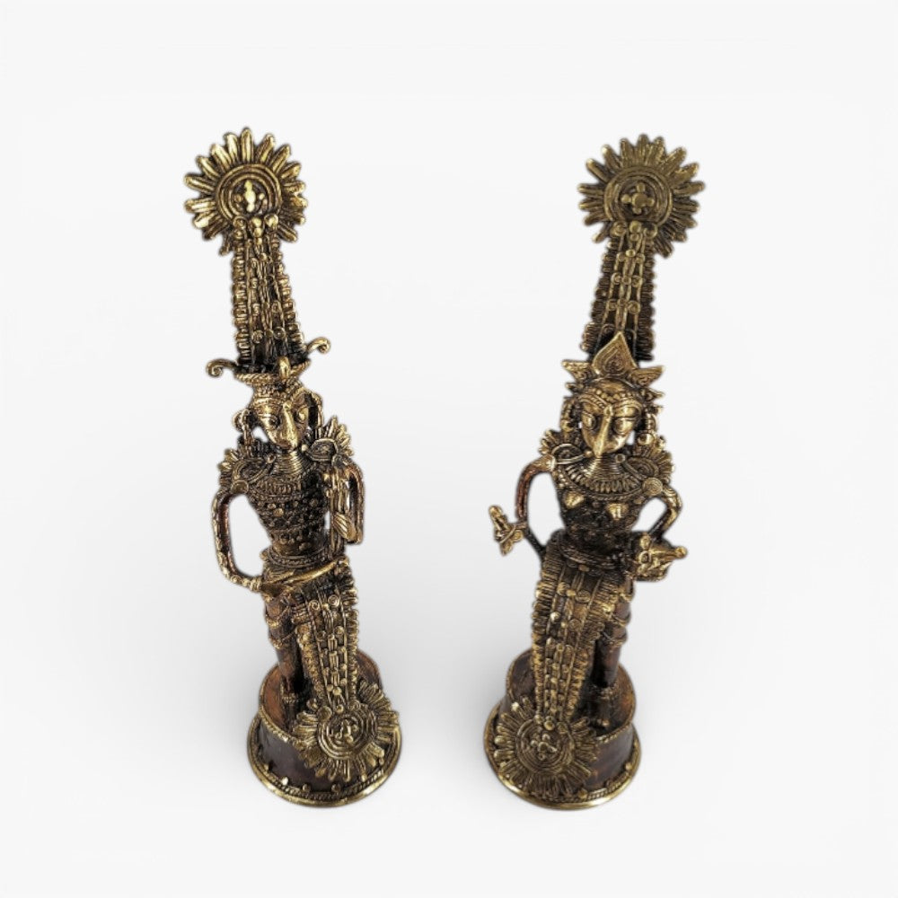 Top angled view of antique bronze finish Jhitku Mitki brass tribal statues highlighting traditional attire and metal detailing