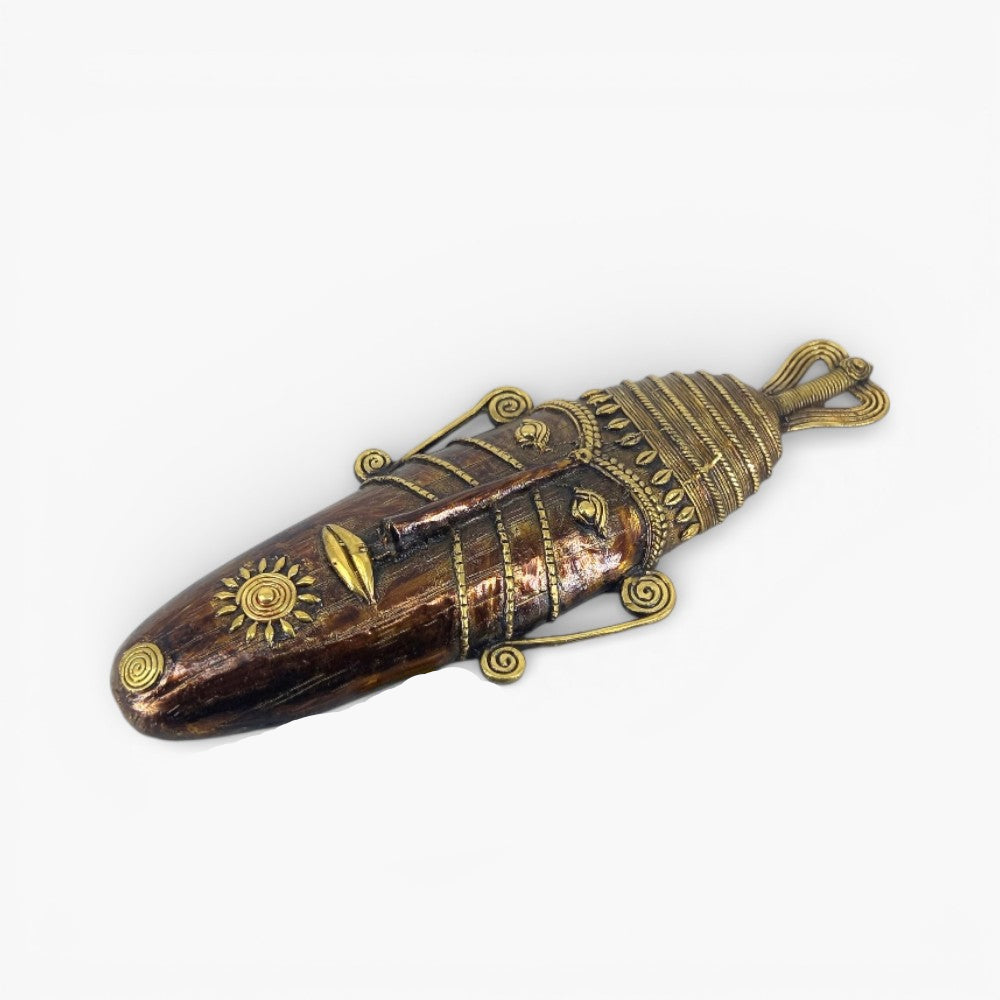 Angled view of Bastar art long face tribal brass mask highlighting ornate facial features and handcrafted Dhokra metal craftsmanship