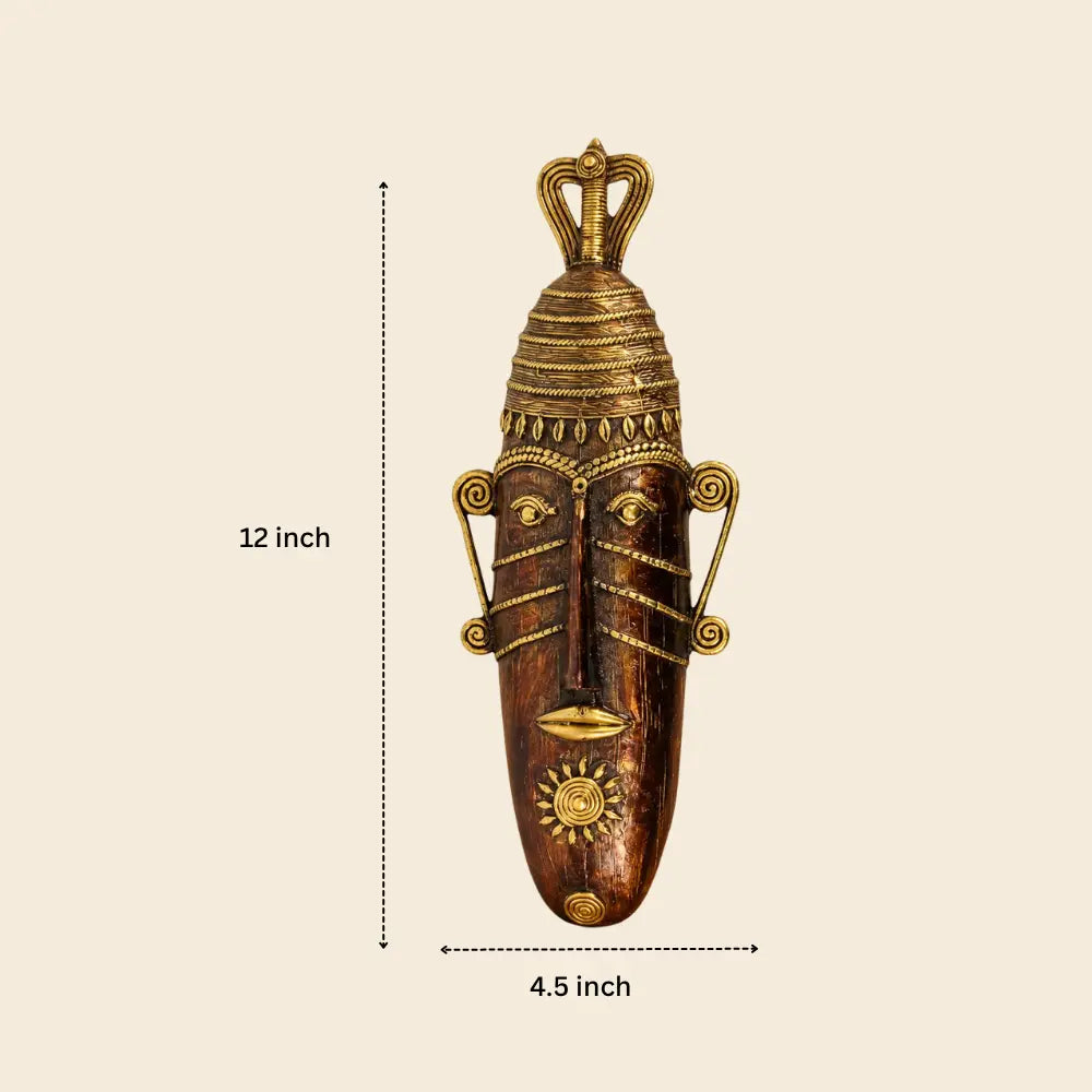 Front view of handcrafted long face tribal brass mask in bronze color showing 12 inch height and traditional Dhokra metal detailing