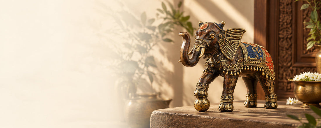 Bastar Dhokra brass elephant with a ball, on a stone ledge