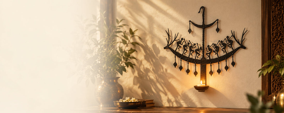 Bastar wrought-iron wall lamp with dancing figures and a lit diya