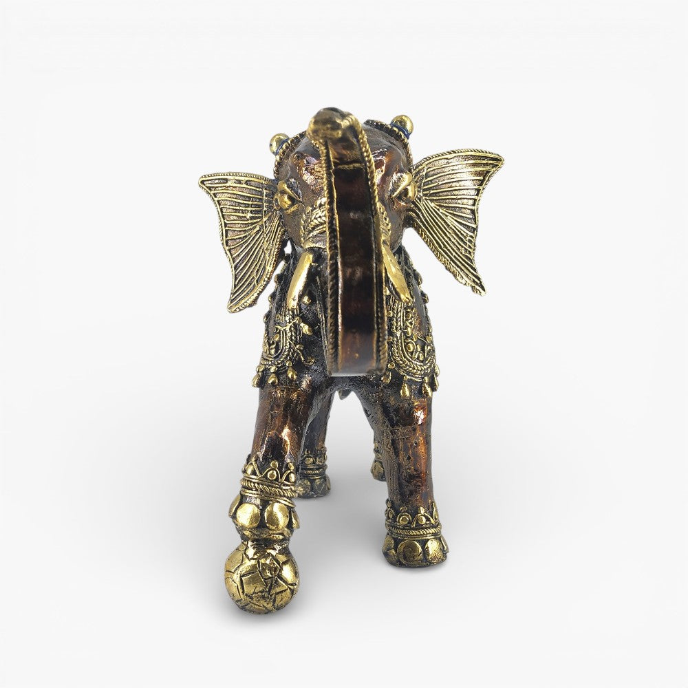 Front view of bronze dhokra soccer playing elephant figurine showcasing raised trunk and ornate ear detailing