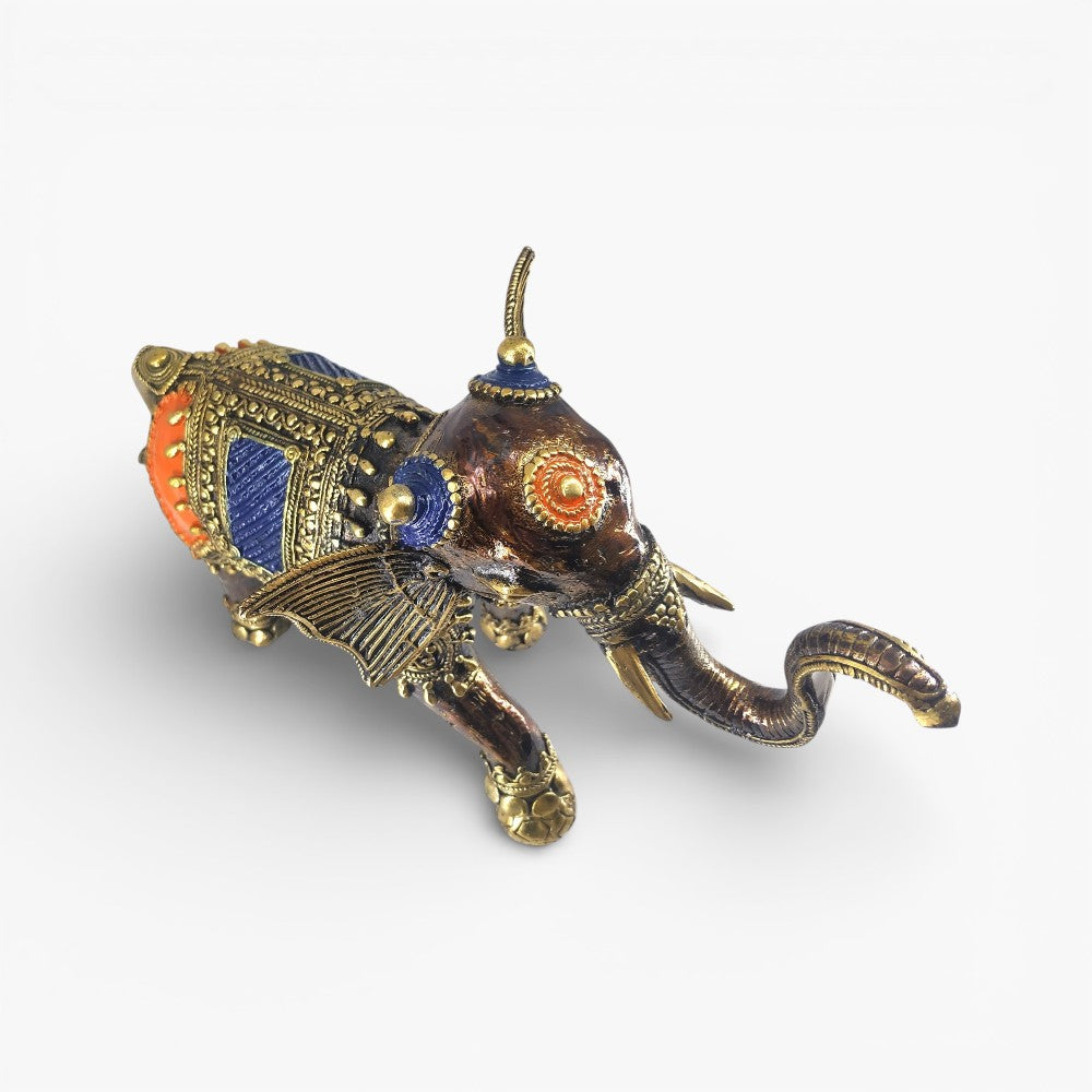 Top three-quarter view of brass dhokra soccer elephant figurine highlighting head ornament and trunk curve