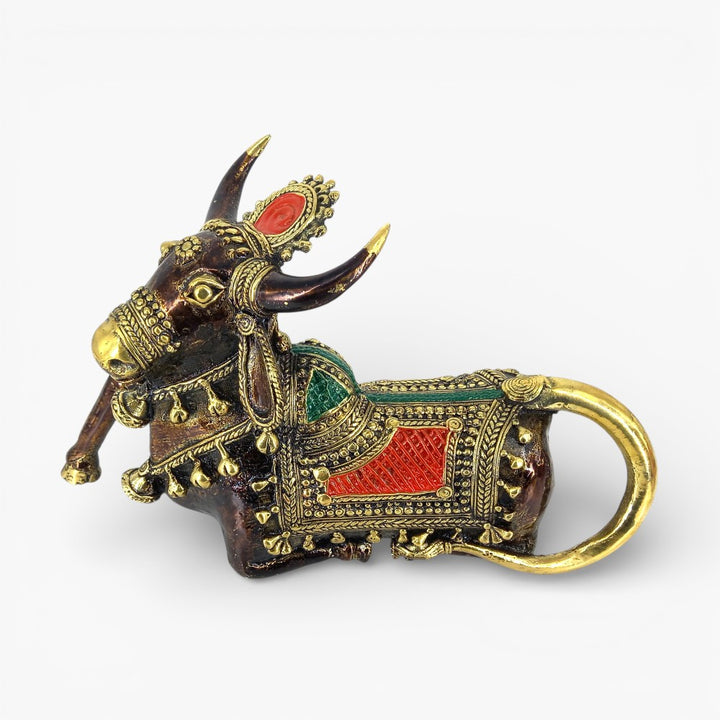 Close-up of brass Nandi sculpture with red green detailing