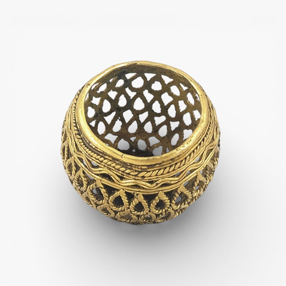 Angled top view of handcrafted brass bulbous pen holder showcasing intricate Dhokra lattice pattern