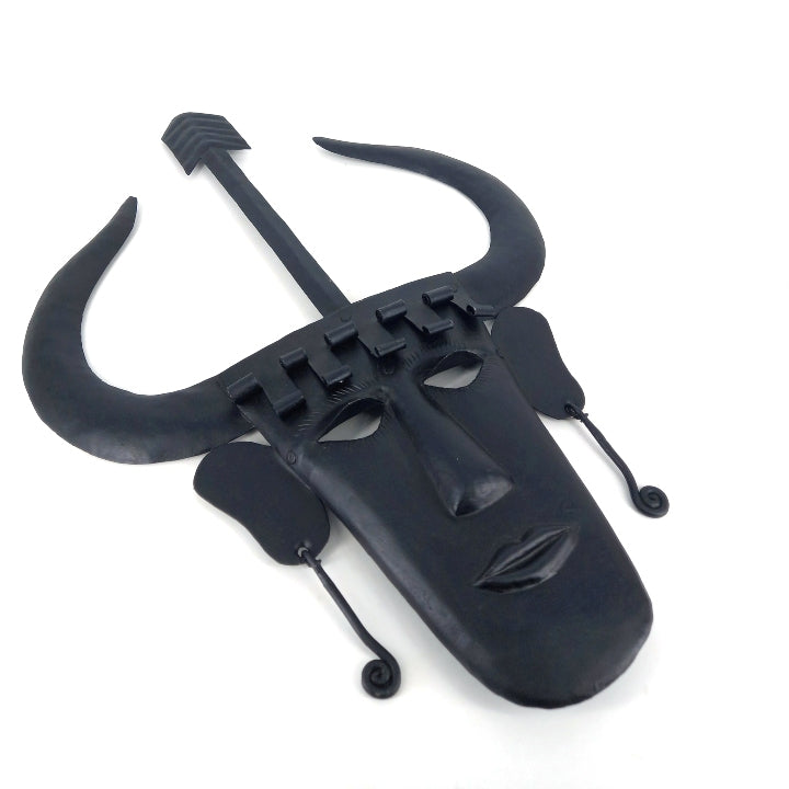 Angled view of handmade Madia tribal Bastar iron wall mask in black showcasing horned design and handcrafted iron texture