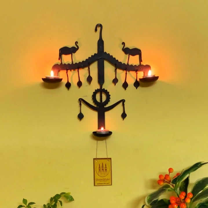 Front view of Bastar iron art elephant wall hanging with candle holders, showcasing traditional handmade iron craftsmanship