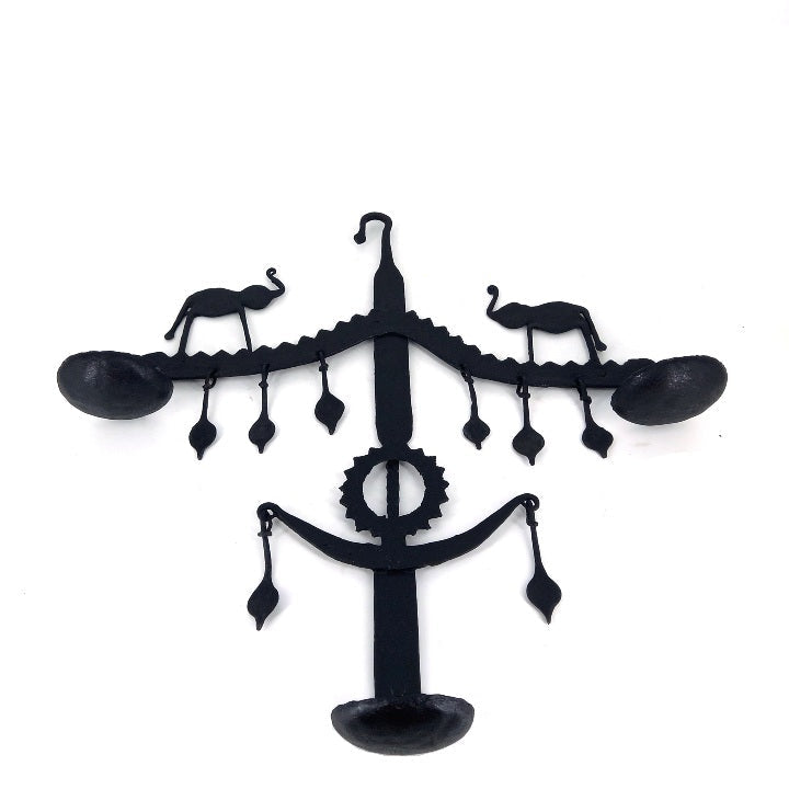 Studio front view of handmade Bastar iron art elephant wall hanging used as decorative wall diya