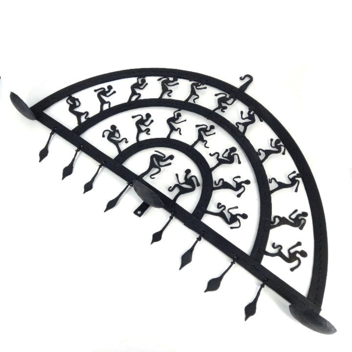 Handmade Bastar iron art half circle wall hanging with multiple curved layers displayed in a studio shot, showcasing folk dancer motifs and solid wrought iron construction