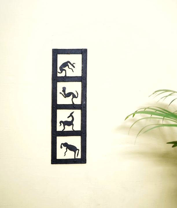 Handmade Bastar iron craft animal kingdom wall panel displayed vertically on a wall, featuring minimalist animal silhouettes in black metal