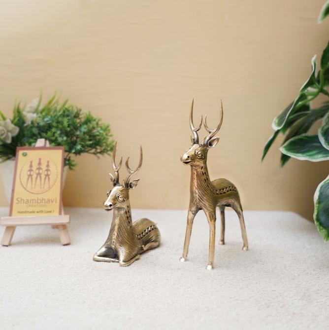 Handcrafted brass deer pair in standing and sitting posture placed on a tabletop, Dokra art animal figurines for elegant home decor
