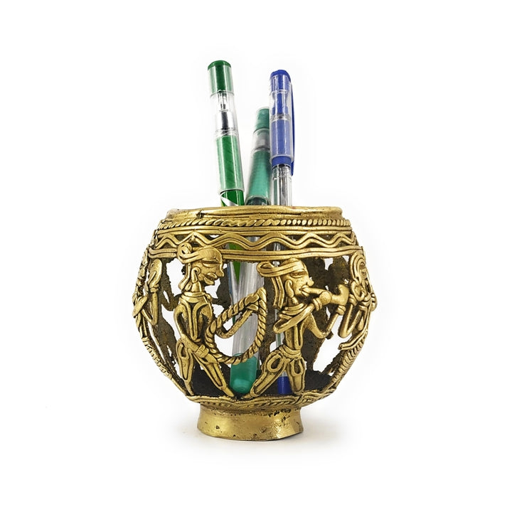 Front view of Dhokra art brass pen holder featuring marching tribal musicians with detailed handcrafted metal work