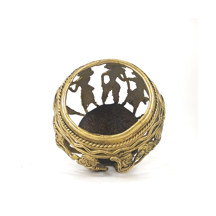 Top view of Dhokra art brass pen holder highlighting circular opening and tribal musician silhouettes
