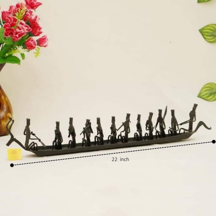 Side view of handmade Bastar iron art deer Kerala boat tabletop showpiece showing 22 inch length and riveted human figure detailing
