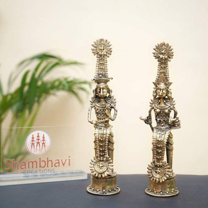 Handcrafted brass Jhitku Mitki tribal couple statue displayed in an elegant indoor setting showcasing Bastar Dokra art detailing 