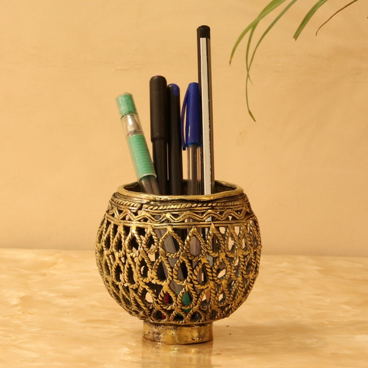 Handcrafted Dhokra art brass bulbous pen holder with ornate jali pattern used as an elegant desk organizer